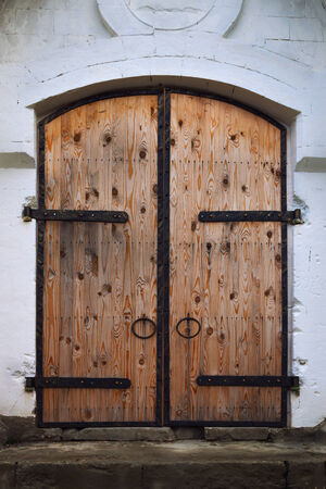 Old metal gate wood paneledの写真素材