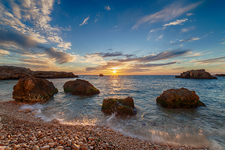 Seascape. Sea coast under blue sky with clouds at sunsetの写真素材