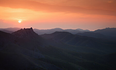 Colorful sunset over the mountain hillsの写真素材