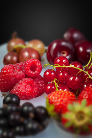 Collection of berries. Strawberries, raspberries, gooseberries, cherries, red and black currantsの写真素材