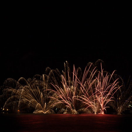 Firework over the water in the night skyの写真素材