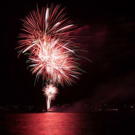Firework over the water in the night skyの写真素材