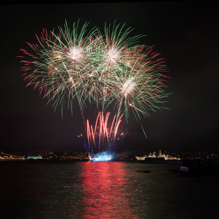 Firework over the water in the night skyの写真素材