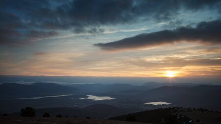 Sunset over the mountain hillsの写真素材