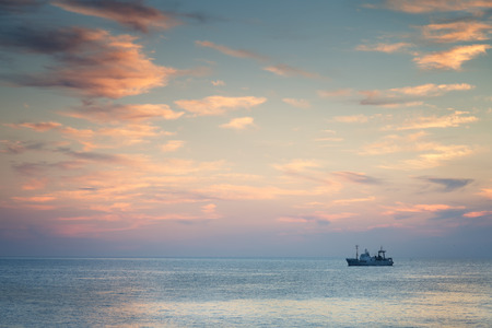 Ship in the sea at sunsetの写真素材