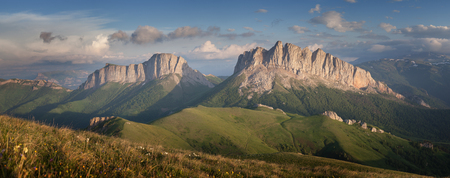 Caucasus mountains (Eastern and Western Acheshbok) under a blue sky with clouds. Caucasus, Russiaの写真素材