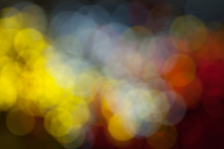 Background of multicolored blurred festive lightsの写真素材