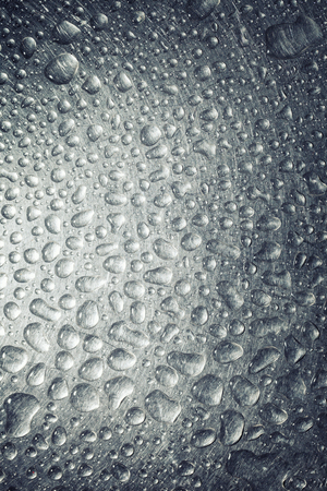Background of the water droplets on a metal surfaceの写真素材