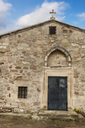 Facade of the ancient church under a blue skyの写真素材
