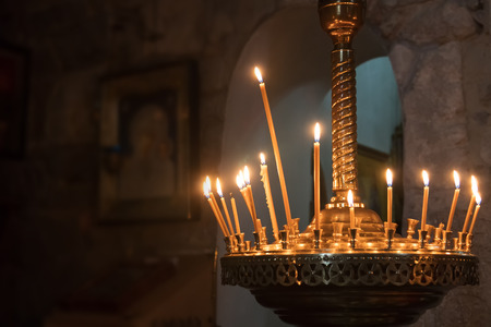 Icons and burning candles in the churchの写真素材