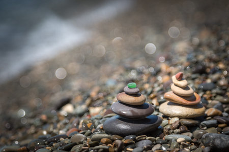 Pyramids of colorful stones on the seashore. Shallow depth of fieldの写真素材