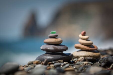 Pyramids of colorful stones on the seashore. Shallow depth of fieldの写真素材