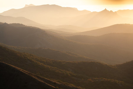 Landscape. Mountain slopes in the mist at sunsetの写真素材