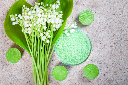 Lily of the valley flowers, bath salt and candles. Spa background.の写真素材