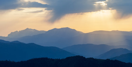 Landscape. Mountain slopes in the mist at sunsetの写真素材