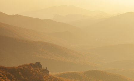 Landscape. Mountain slopes in the mist at sunsetの写真素材