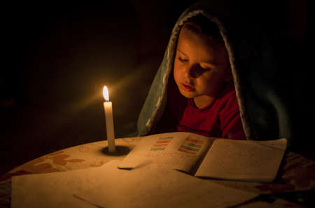 poor child study with candle light tonaightの写真素材