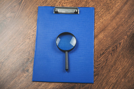 magnifier on document on the wooden desk