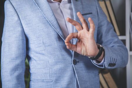 man hand okay sign in the office deskの写真素材
