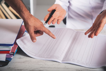 two worker hand document on the desk