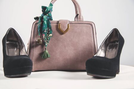 woman shoes with bag on white tableの写真素材