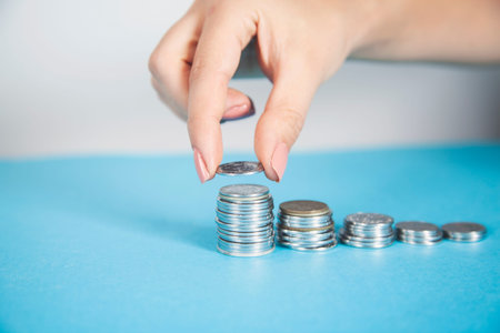 woman hand holding coins on the desk