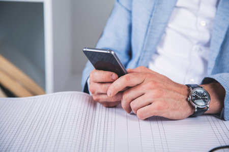 man hand phone with document on the desk