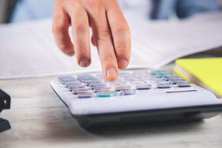 man hand calculator and  document on the deskの写真素材