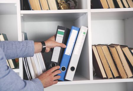 business man hand documents in office backgroundの写真素材