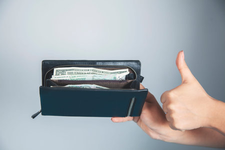 woman hand okay sign with money on  wallet