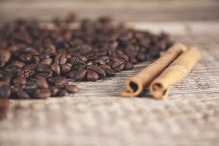 coffee grains with cinnamon on deskの写真素材