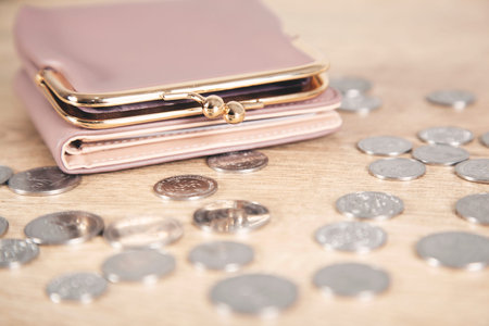 coins with wallet on the wooden table