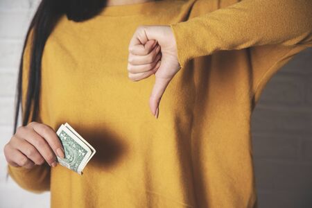 woman hand money with bad sign on white backgroundの写真素材