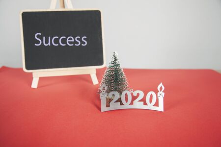 success taxt on chalkboard with christmas treeの写真素材
