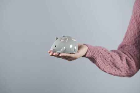 woman hand holding mouse toy on gray backgroundの写真素材