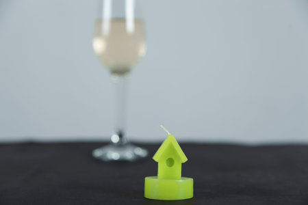 glass of champagne with house model on deskの写真素材