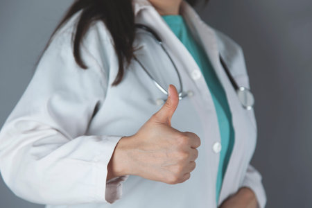 woman doctor hand okay sign on dark background
