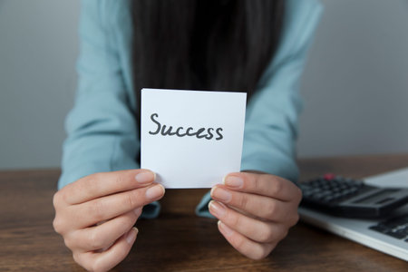 woman hand holding success text on pageの写真素材