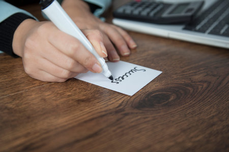 woman hand success text on page on desk