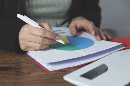woman hand pen with graph on the deskの写真素材