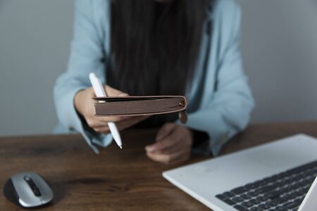 woman hand notepad in the office deskの写真素材