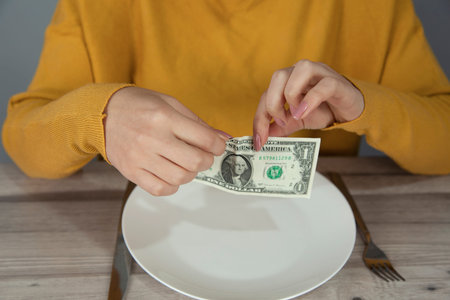 woman  hand  dollar on  plate on desk