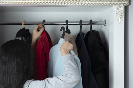 woman hand dress of hanger in the lockerの写真素材