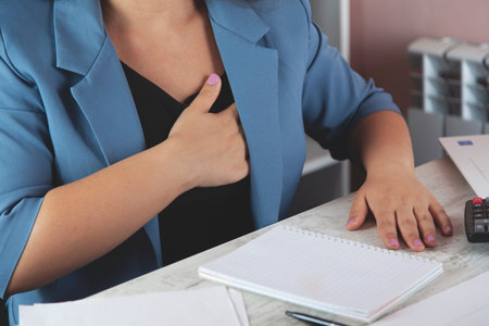business woman hand ache heart in the office