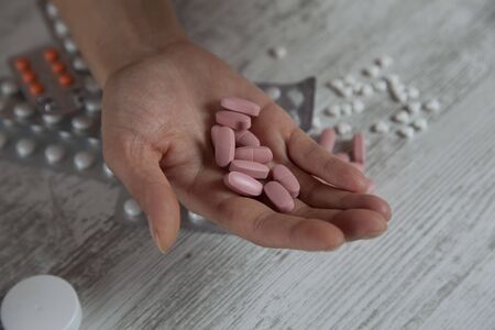 woman hand drug with water on deskの写真素材