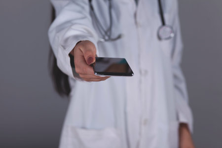 doctor hand smart phone on grey background