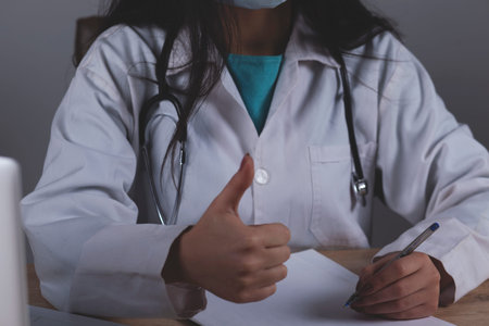 doctor hand okay sign on the gray wall backgroundの写真素材