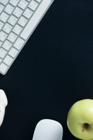 notepad with keyboard and apple on desk