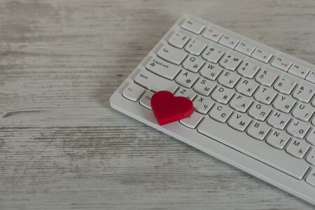 red heart on computer keyboard on the tableの写真素材