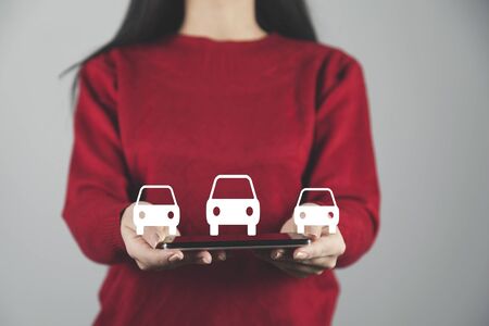 woman hand phone with car models in screenの写真素材